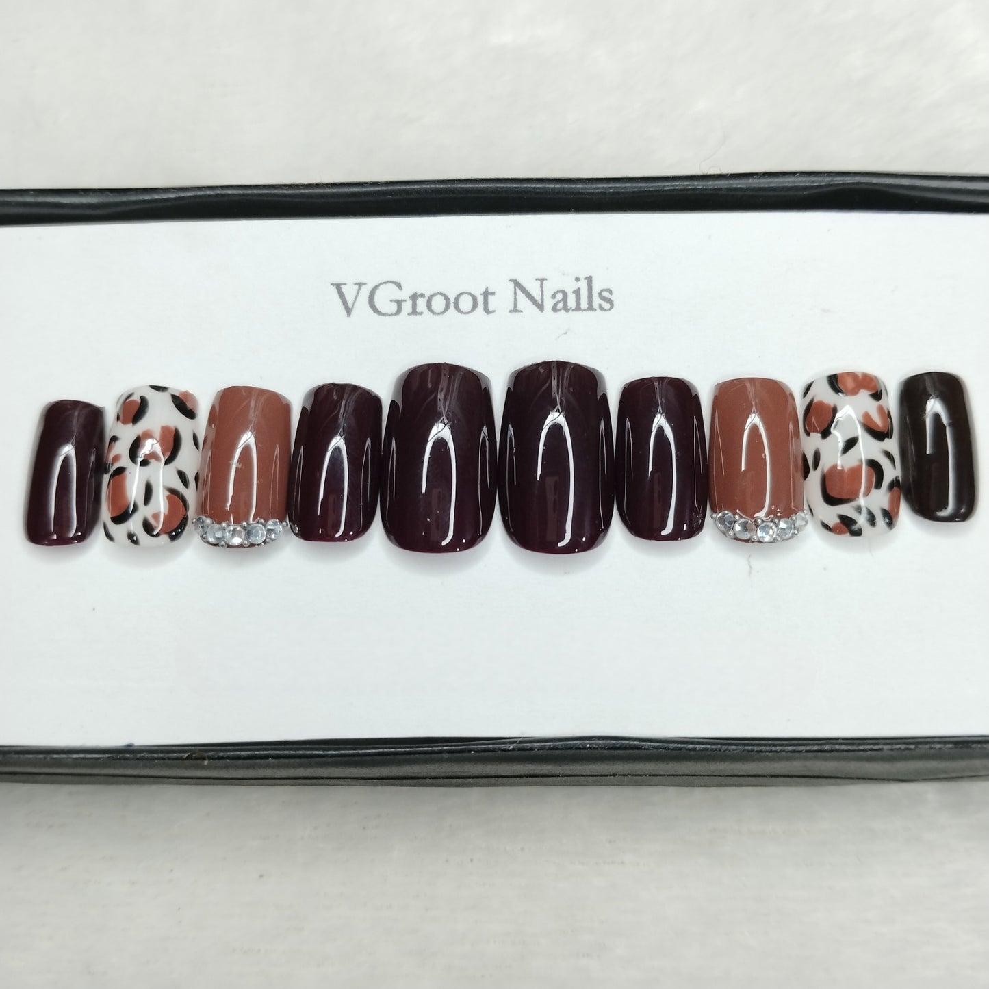 The NailzStation Glossy Black Studded Animal Print Press on Fake Artificial Nails Set with glue, filer, sticker application kit // 1103