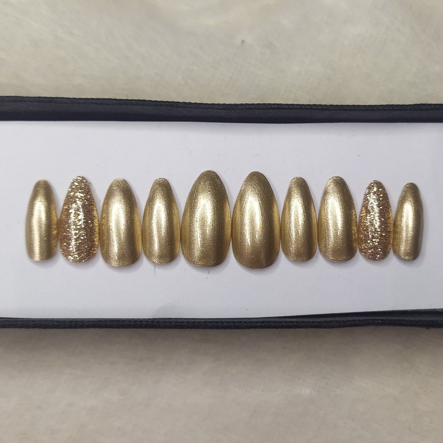 The NailzStation Glossy Golden Glitter Press on Fake Artificial Nails Set with glue, filer, sticker application kit // 1312