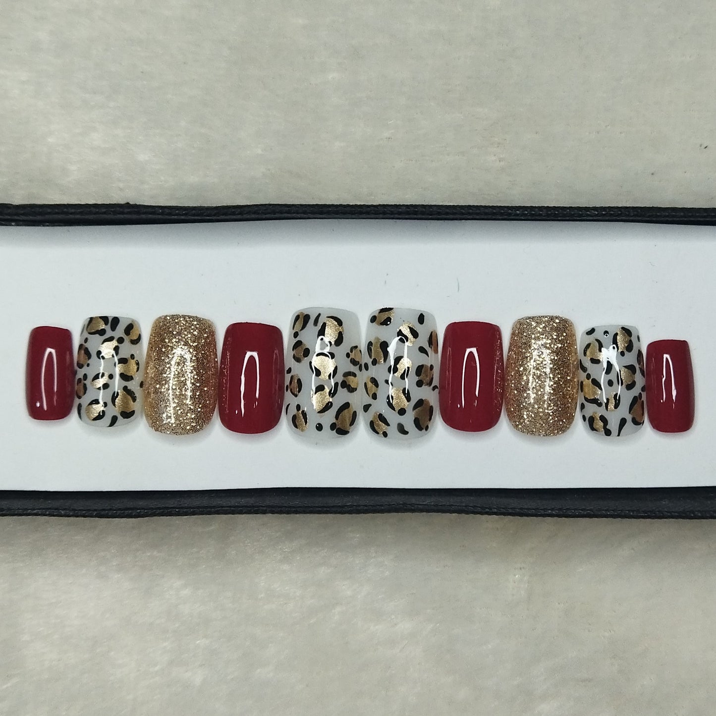 The NailzStation Glossy Red Animal Print Press on Fake Artificial Nails Set with glue, filer, sticker application kit // 1311