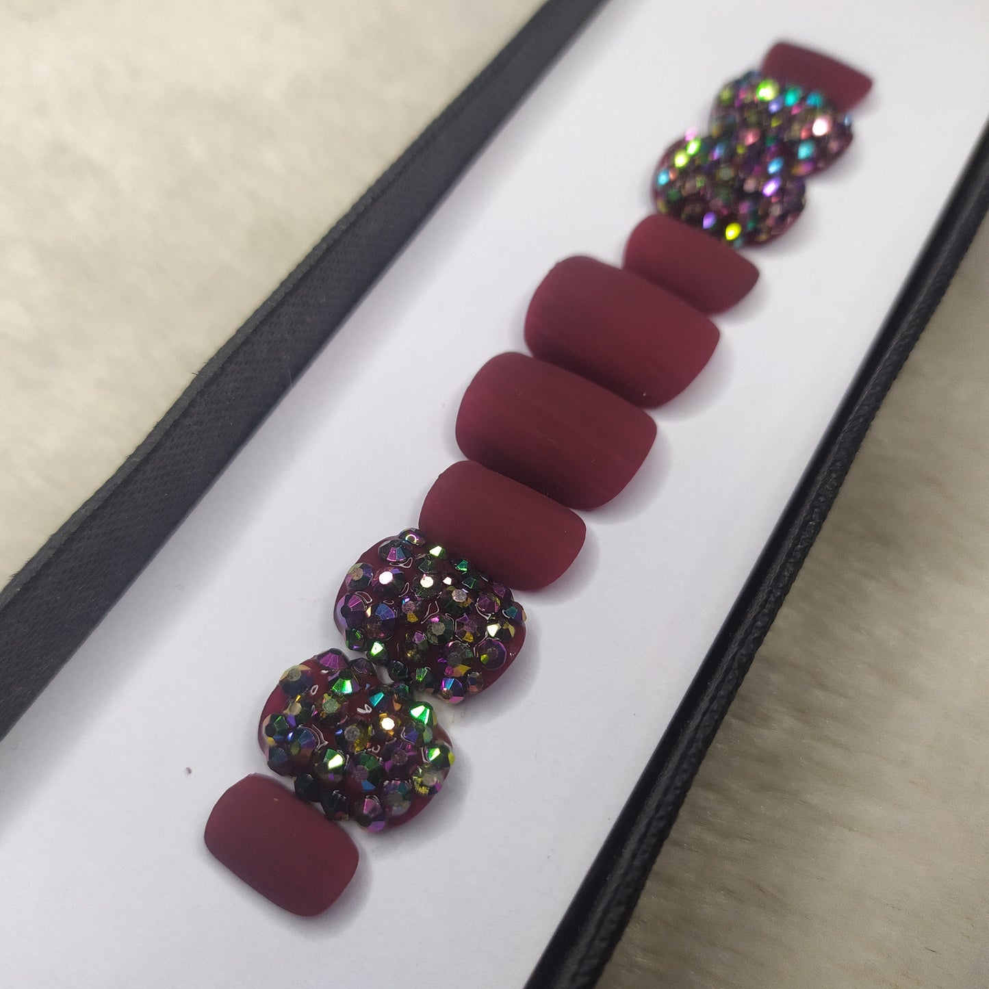 The NailzStation Glossy Maroon Studded Press on Fake Artificial Nails Set with glue, filer, sticker application kit // 1286