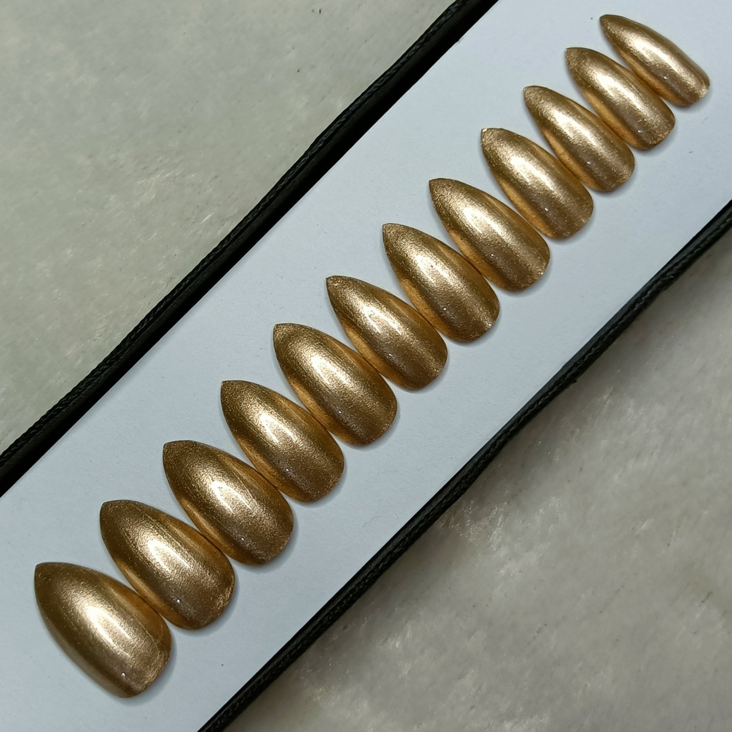 The NailzStation Glossy Golden Press on Fake Artificial Nails Set with glue, filer, sticker application kit // 1284