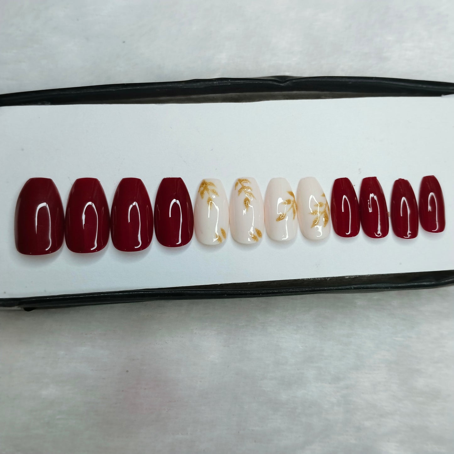 The NailzStation Glossy Maroon Glitter Leaves Press on Fake Artificial Nails Set with glue, filer, sticker application kit // 1265