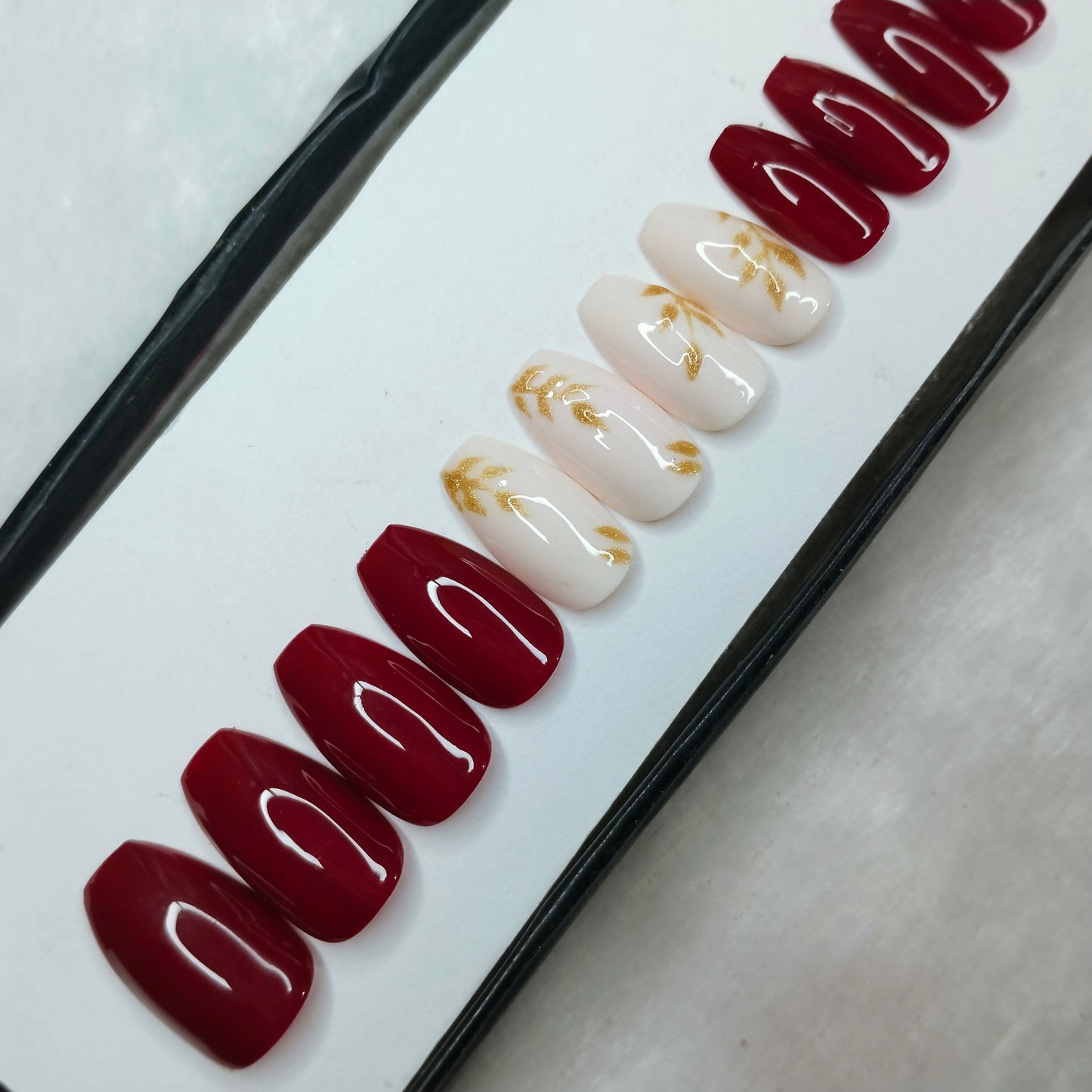 The NailzStation Glossy Maroon Glitter Leaves Press on Fake Artificial Nails Set with glue, filer, sticker application kit // 1265