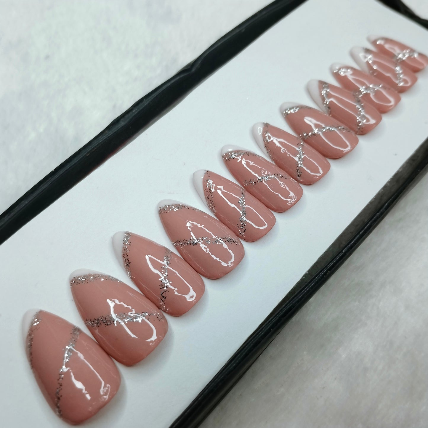 The NailzStation Glossy Nude Glitter Swirls Press on Fake Artificial Nails Set with glue, filer, sticker application kit // 1260